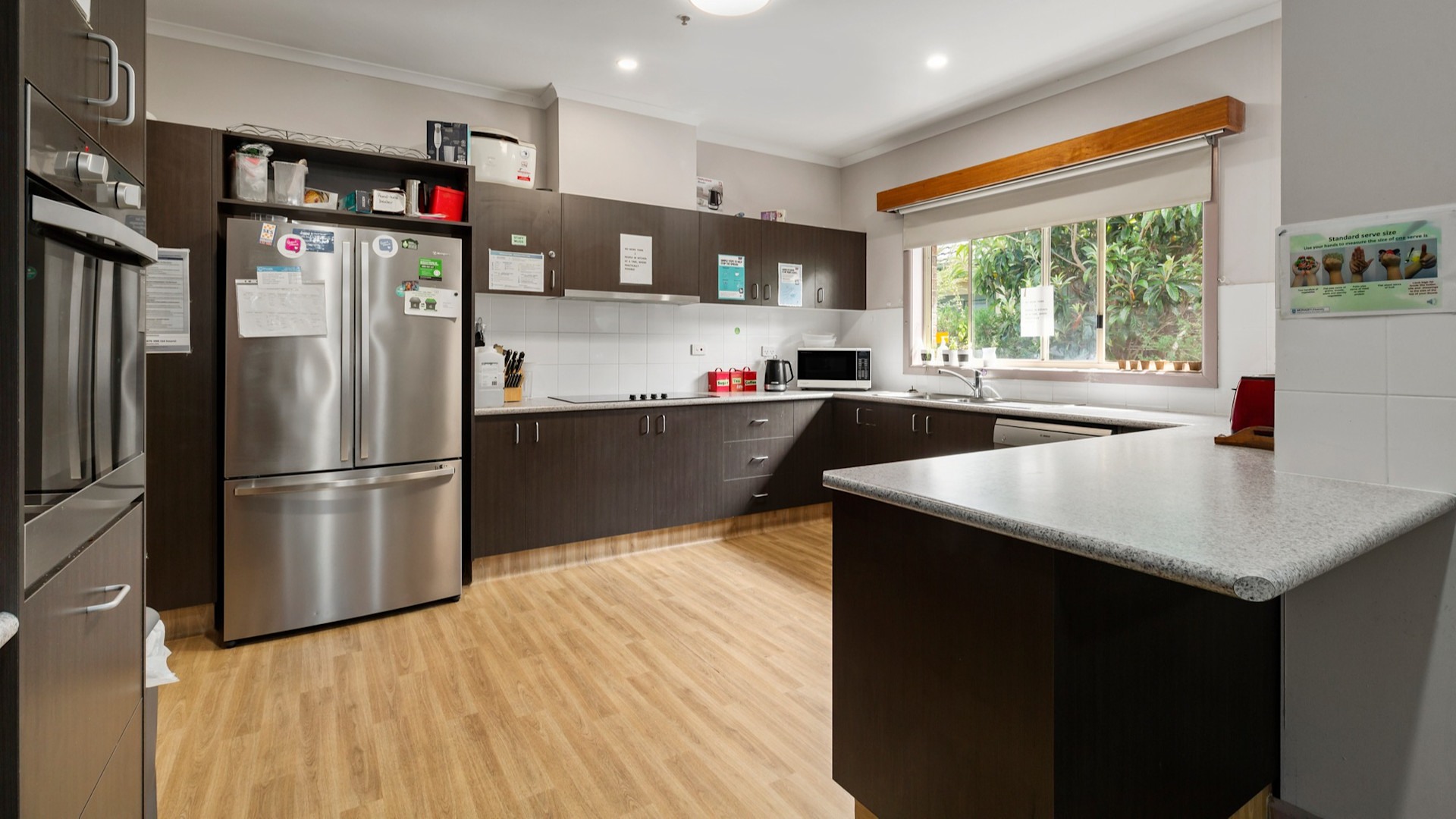 --Large wrap around kitchen, wooden floor boards.--
