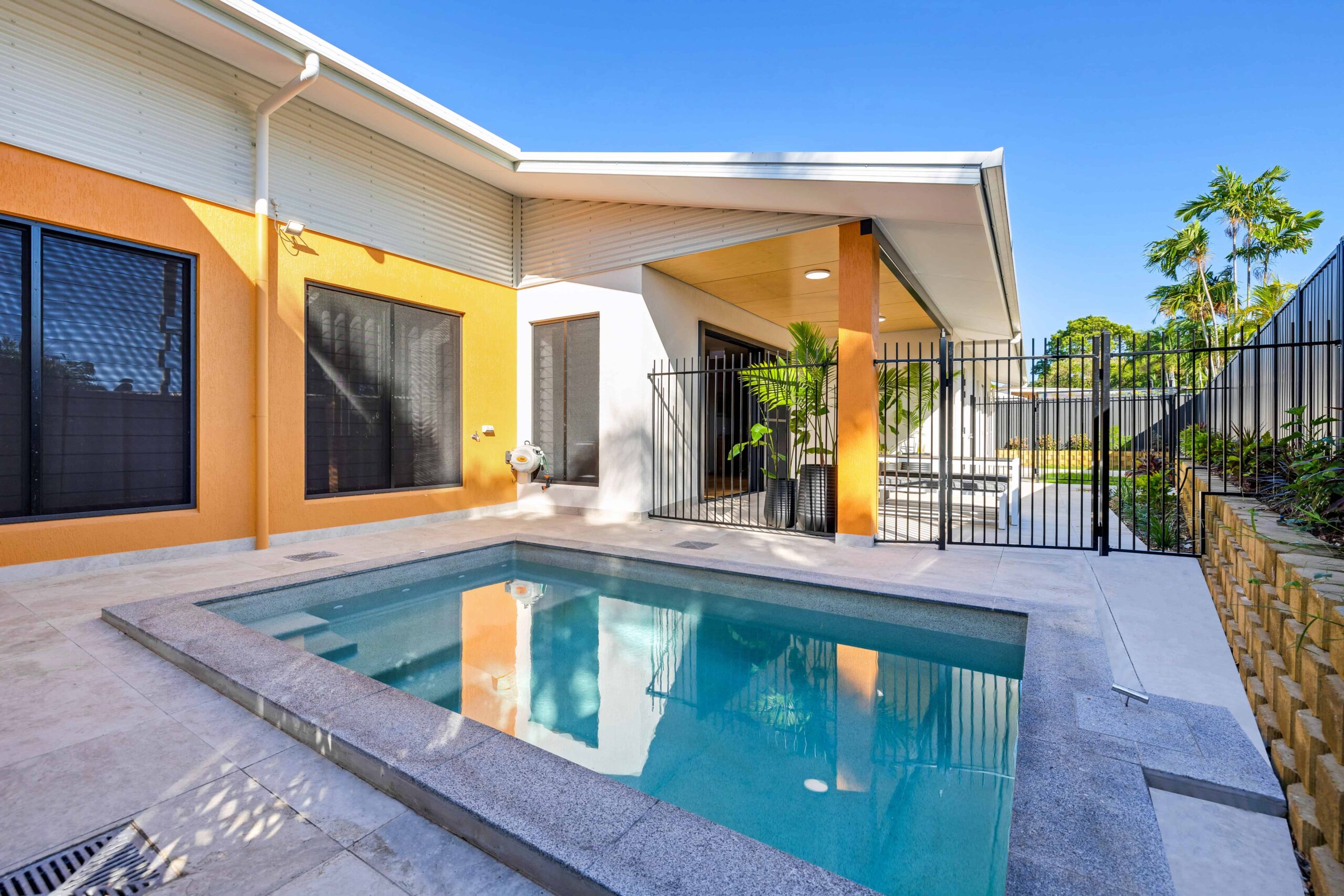 SDA pool area, highlighting an orange exterior feature wall.