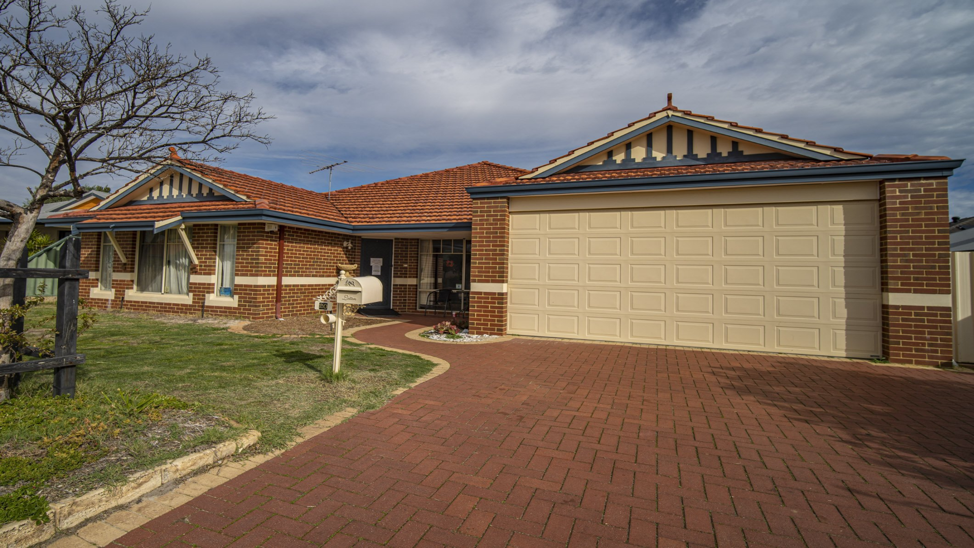 --Front of High Wycombe House with a brick driveway leading to a garage.--
